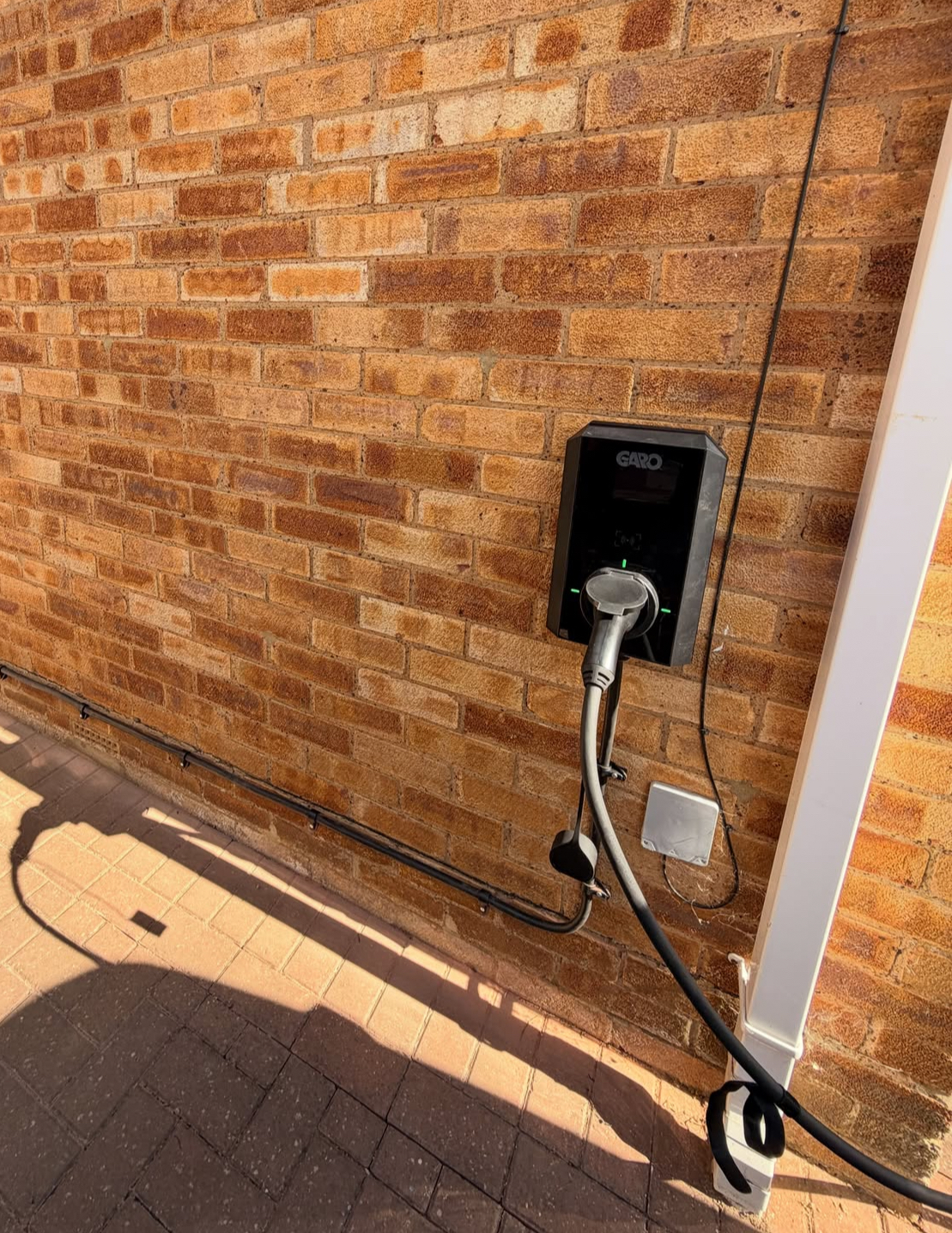 Garo EV charger installed on a brick wall with a surface cable route